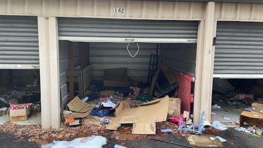 A self storage unit broken into and vandalized, contents damaged and scattered across the floor