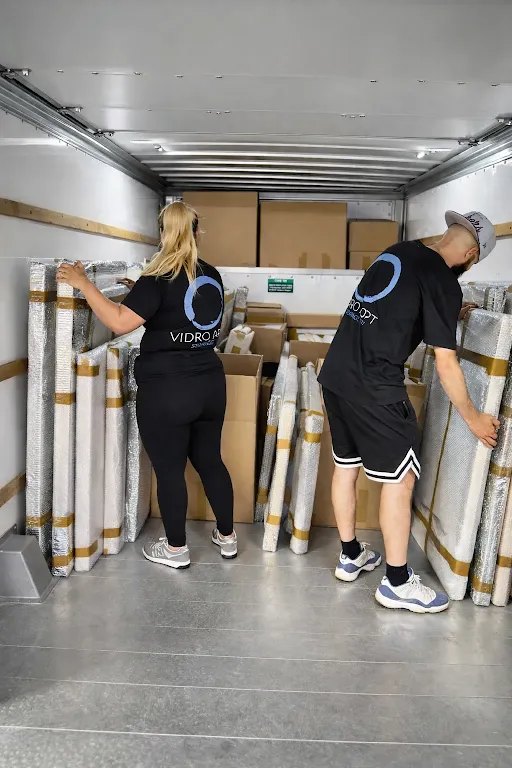 Two Vidro Art Storage handlers loading padded and wrapped artwork into a climate-controlled transport truck in Los Angeles